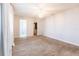 Large bedroom features a chandelier, wood-look tile flooring, closet and bathroom access at 1049 Presque Isle Dr, Port Charlotte, FL 33952