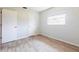 Bedroom with wood-look tile flooring, window, and closet at 1049 Presque Isle Dr, Port Charlotte, FL 33952