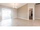 Neutral dining room area with tile floors and a sliding door that leads to an enclosed patio at 1049 Presque Isle Dr, Port Charlotte, FL 33952