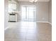 Open dining area with tiled floors, sliding glass doors, and partial view of the kitchen at 1049 Presque Isle Dr, Port Charlotte, FL 33952