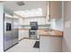 Bright kitchen features stainless steel appliances, white cabinetry and a skylight at 1049 Presque Isle Dr, Port Charlotte, FL 33952