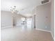 Open-concept living area with tiled floors and views of the kitchen and dining space at 1049 Presque Isle Dr, Port Charlotte, FL 33952