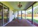 Covered patio with plants and easy access to the grassy backyard at 1049 Presque Isle Dr, Port Charlotte, FL 33952
