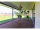 Enclosed patio showing view of backyard with grass, shed and wooden fence at 1049 Presque Isle Dr, Port Charlotte, FL 33952