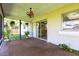 Enclosed porch area with hanging plants and tiled flooring, perfect for relaxing at 1049 Presque Isle Dr, Port Charlotte, FL 33952