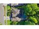 Aerial shot of home with lush surroundings and sparkling screened-in private pool at 4404 Grainary Ave, Tampa, FL 33624