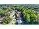Aerial view of a charming single-Gathering home with lush landscaping and mature trees at 4404 Grainary Ave, Tampa, FL 33624