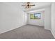 Bright bedroom with plush carpeting, a ceiling fan, and a large closet at 4404 Grainary Ave, Tampa, FL 33624