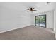 This bedroom offers a ceiling fan and sliding doors leading to a back porch area at 4404 Grainary Ave, Tampa, FL 33624