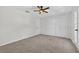 Bright bedroom with plush carpeting, a ceiling fan, and a large closet at 4404 Grainary Ave, Tampa, FL 33624