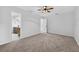 This bedroom offers neutral walls, carpet, and an open doorway to the bathroom at 4404 Grainary Ave, Tampa, FL 33624