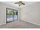 This bedroom offers a ceiling fan and sliding doors leading to a porch area at 4404 Grainary Ave, Tampa, FL 33624
