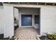 Inviting entryway featuring double doors, brick accents, and a charming brick walkway at 4404 Grainary Ave, Tampa, FL 33624