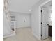 Entryway boasting neutral paint, tile floors, stairs to the second floor and access to the downstairs bathroom at 4404 Grainary Ave, Tampa, FL 33624