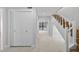 Bright foyer with tile flooring, closet, and staircase with white risers at 4404 Grainary Ave, Tampa, FL 33624