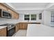 Bright kitchen featuring stainless steel appliances, white countertops, and natural wood cabinets at 4404 Grainary Ave, Tampa, FL 33624