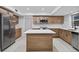 Modern kitchen with stainless steel appliances, white countertops, and wooden cabinetry at 4404 Grainary Ave, Tampa, FL 33624
