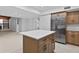 Open kitchen with island, stainless steel appliances, and tile flooring at 4404 Grainary Ave, Tampa, FL 33624
