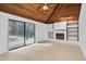 Bright living room boasts vaulted wood ceilings, tile floors, fireplace and access to the outdoor pool at 4404 Grainary Ave, Tampa, FL 33624