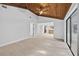 Bright living room features vaulted ceilings, tile flooring, and an open design to the kitchen at 4404 Grainary Ave, Tampa, FL 33624