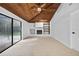 Bright living room boasts vaulted wood ceilings, tile floors, fireplace and access to the outdoor pool at 4404 Grainary Ave, Tampa, FL 33624