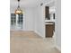 Open living room with neutral paint, tile floors, chandelier and open layout to the kitchen at 4404 Grainary Ave, Tampa, FL 33624