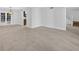 Open living room with neutral paint, tile floors, a modern chandelier and stairs to the second floor at 4404 Grainary Ave, Tampa, FL 33624