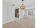 Open living room with neutral paint, tile floors, a modern chandelier and views to the kitchen at 4404 Grainary Ave, Tampa, FL 33624