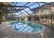Sparkling private pool enclosed in a screened-in lanai and a brick-paved deck at 4404 Grainary Ave, Tampa, FL 33624