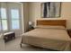 Cozy bedroom featuring soft carpet, natural light, and a comfortable bed at 4926 Anniston Cir, Tampa, FL 33647