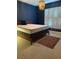 Bedroom with plantation shutters, a decorative chandelier, and a colorful area rug at 4926 Anniston Cir, Tampa, FL 33647