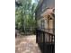 Charming home featuring a wooden deck with black railings and views of mature trees at 4926 Anniston Cir, Tampa, FL 33647