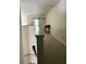 Upstairs hallway featuring neutral carpet and a view of the den at 4926 Anniston Cir, Tampa, FL 33647