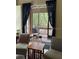 Relaxing living area featuring stylish seating, dark curtains, and sliding glass doors to a deck at 4926 Anniston Cir, Tampa, FL 33647