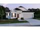 Single-story home featuring a 2 car garage, charming architectural details and neat front lawn at 12515 Shafton Rd, Spring Hill, FL 34609