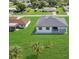 Aerial view of the back of the home with a patio surrounded by a well-maintained lawn at 3323 Elkcam Blvd, Port Charlotte, FL 33952