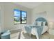 Comfortable bedroom with a large window view and blue accents, creating a serene and inviting space at 3323 Elkcam Blvd, Port Charlotte, FL 33952