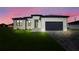 Beautiful single-Gathering home with manicured lawn and modern design elements in a serene setting at 3323 Elkcam Blvd, Port Charlotte, FL 33952