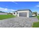 Modern home with brick driveway and lawn at 3323 Elkcam Blvd, Port Charlotte, FL 33952