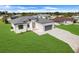 Charming one-story home featuring a manicured lawn, modern design, and a convenient two-car garage at 3323 Elkcam Blvd, Port Charlotte, FL 33952