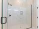 Modern bathroom featuring a frameless glass shower with marble tile and black hardware at 3323 Elkcam Blvd, Port Charlotte, FL 33952