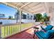 Covered back porch with outdoor seating, overlooking a grassy yard and nearby buildings at 4311 123Rd W St, Cortez, FL 34215