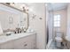 Modern bathroom with marble vanity, stylish mirror, and a walk-in shower at 4311 123Rd W St, Cortez, FL 34215