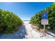 Scenic beach access with lush dunes and clear signage, promoting conservation and regulations for responsible enjoyment at 4311 123Rd W St, Cortez, FL 34215