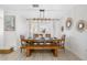 Bright dining room featuring wooden table and chairs, a bench and modern lighting fixture at 4311 123Rd W St, Cortez, FL 34215