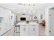 Bright, open-concept kitchen featuring a large island with seating and modern pendant lighting at 4311 123Rd W St, Cortez, FL 34215