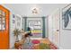Cozy office space featuring a bright orange entry door and access to the deck at 4311 123Rd W St, Cortez, FL 34215