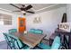 Inviting outdoor dining area with a white brick wall, colorful decor, and seating for six at 4311 123Rd W St, Cortez, FL 34215