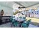 Relaxing covered patio with seating and views of lush tropical landscaping at 4311 123Rd W St, Cortez, FL 34215