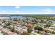 Neighborhood aerial featuring a home amid lush landscapes near a lake, offering serene surroundings at 3410 Allandale Dr, Holiday, FL 34691